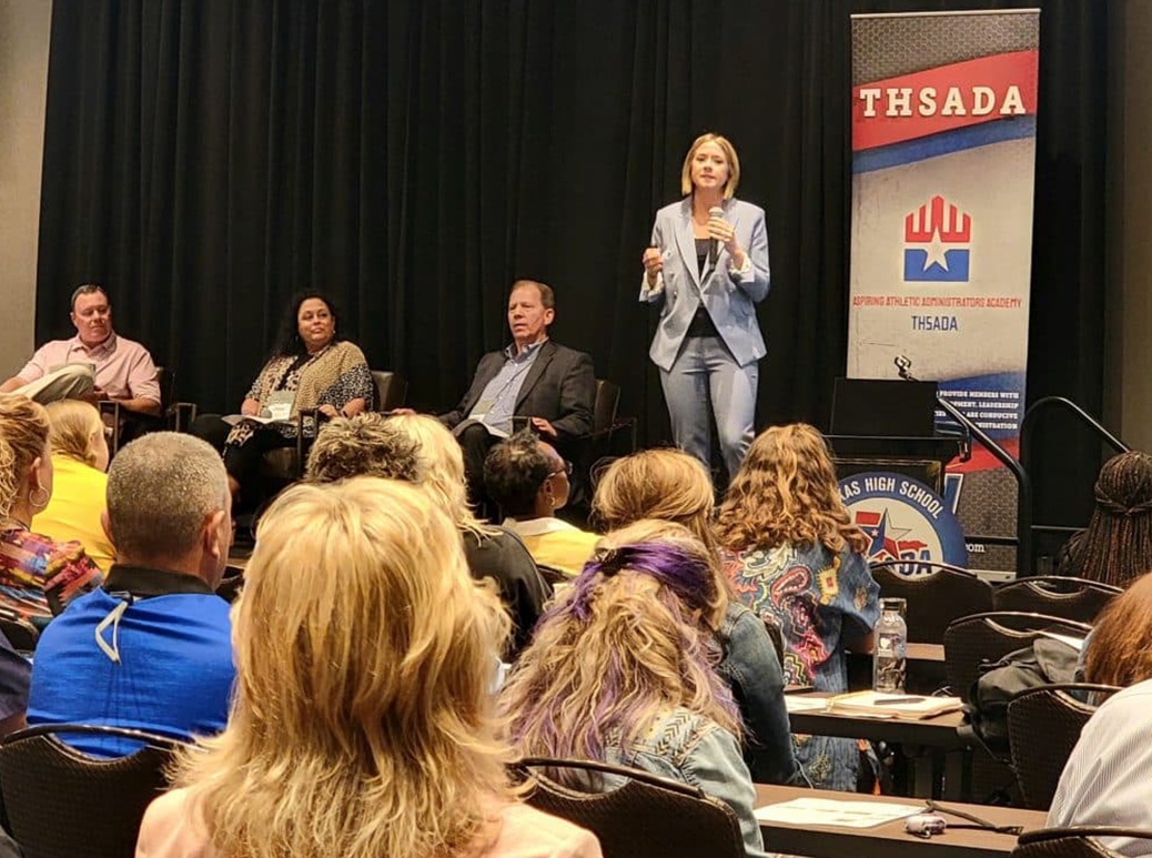 a group of people sitting and standing in front of a crowd