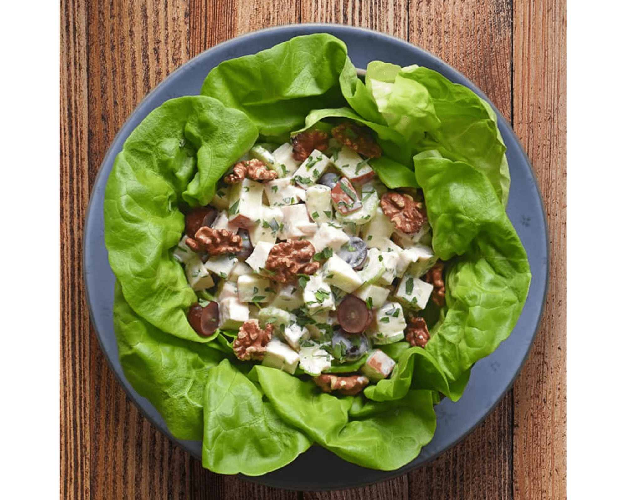 a pizza sitting on top of a wooden lettuce filled with food